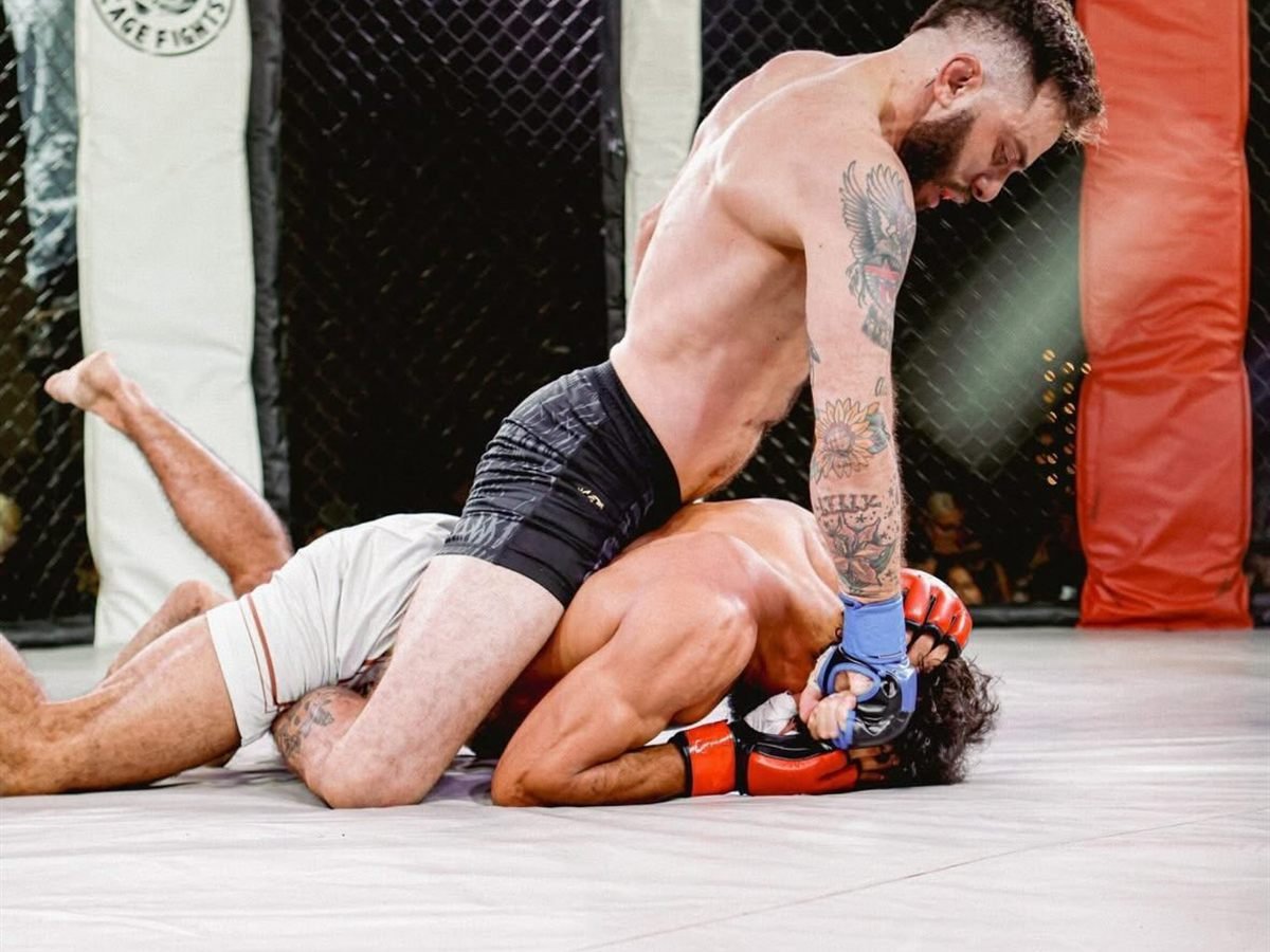 A Furst Place MMA fighter controlling an opponent on the ground during a cage fight